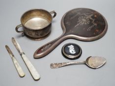 A silver two handled bowl, a silver mounted hand mirror, two silver and mother of pearl fruit