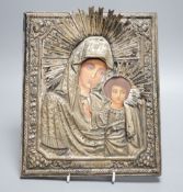 A Russian icon of Madonna and child, in embossed white metal frame, 27cm high