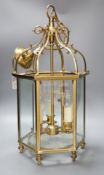 A three light brass hall lantern in hexagonal glass opening case - 56cm high excluding ceiling