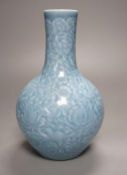 A Chinese blue-glazed moulded bottle vase - 23cm high