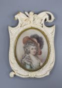 A 19th century carved ivory frame housing an indistinctly signed portrait miniature of a lady 14cm