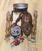 A group of African hardwood carvings, shell and beadwork including a cap