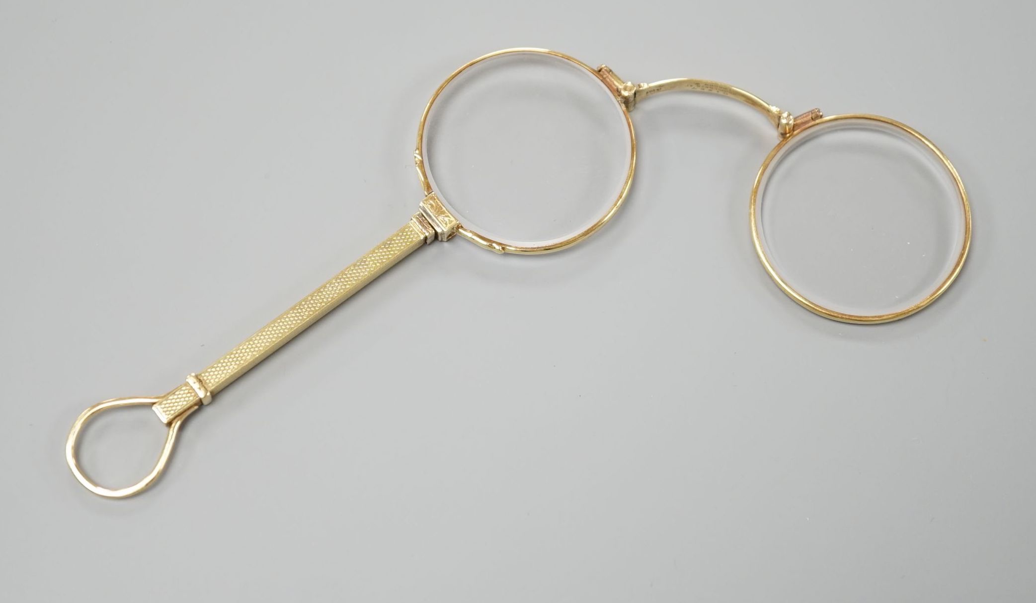 A pair of Edwardian 15ct lorgnettes, by Dixie, 20 Welbeck Street, London, with engine turned handle,