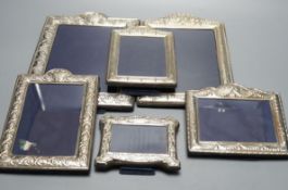 Two modern graduated pairs of decorated silver mounted photograph frames, Carrs of Sheffield,