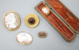 A Victorian yellow metal and cabochon garnet set circular brooch, 31mm, gross 9.3 grams, a stick pin