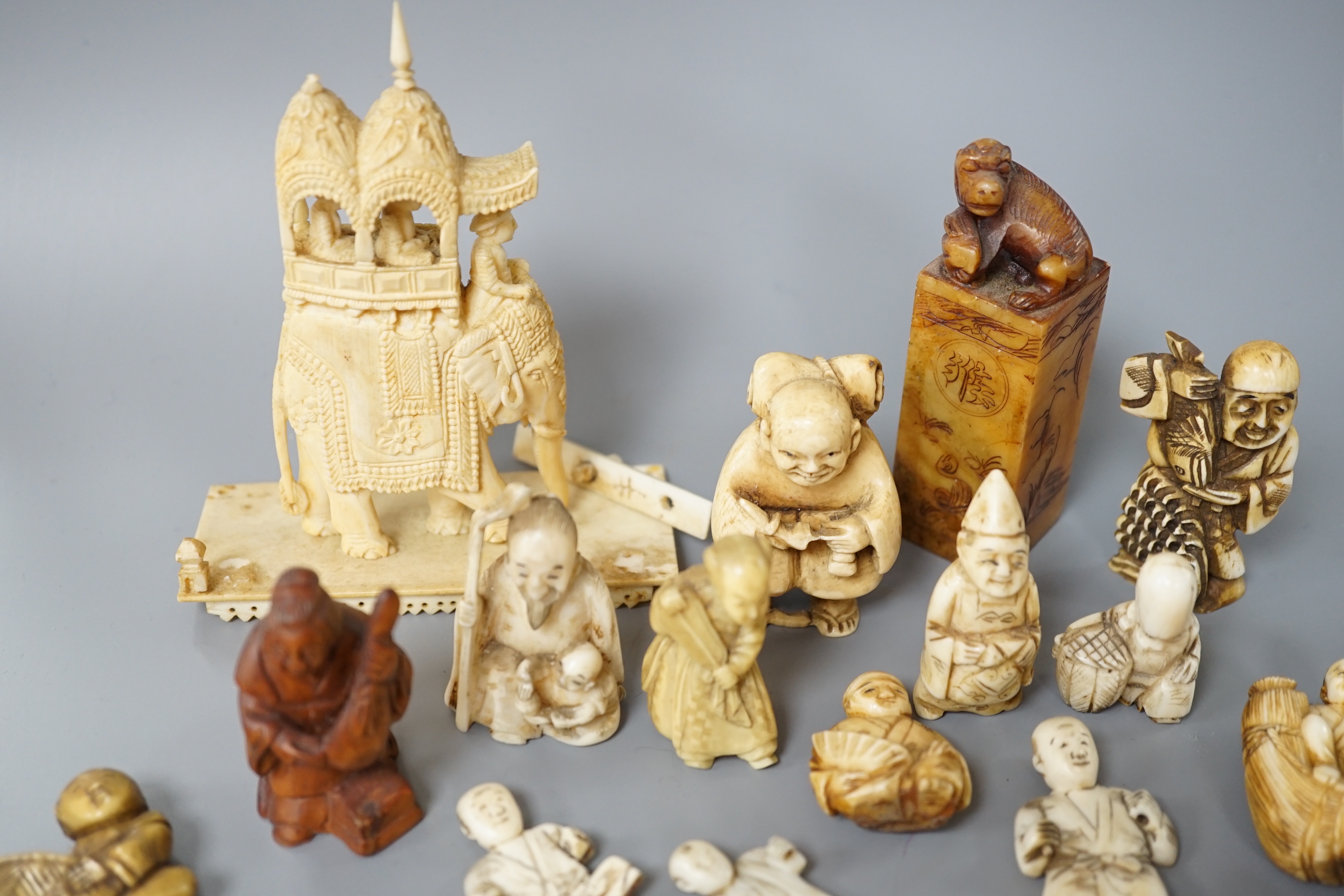 A collection of various ivory carvings including netsuke, a soapstone seal and carved wood netsuke - Image 4 of 8