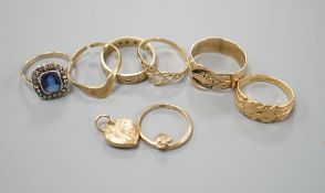 Four assorted 9ct gold rings, a 9ct gold heart pendant and a 9ct and paste set ring, gross 8.3