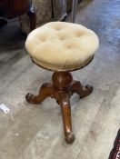 A Victorian oak revolving piano stool