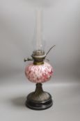 A 19th century mottled glass oil lamp, 55cm total height