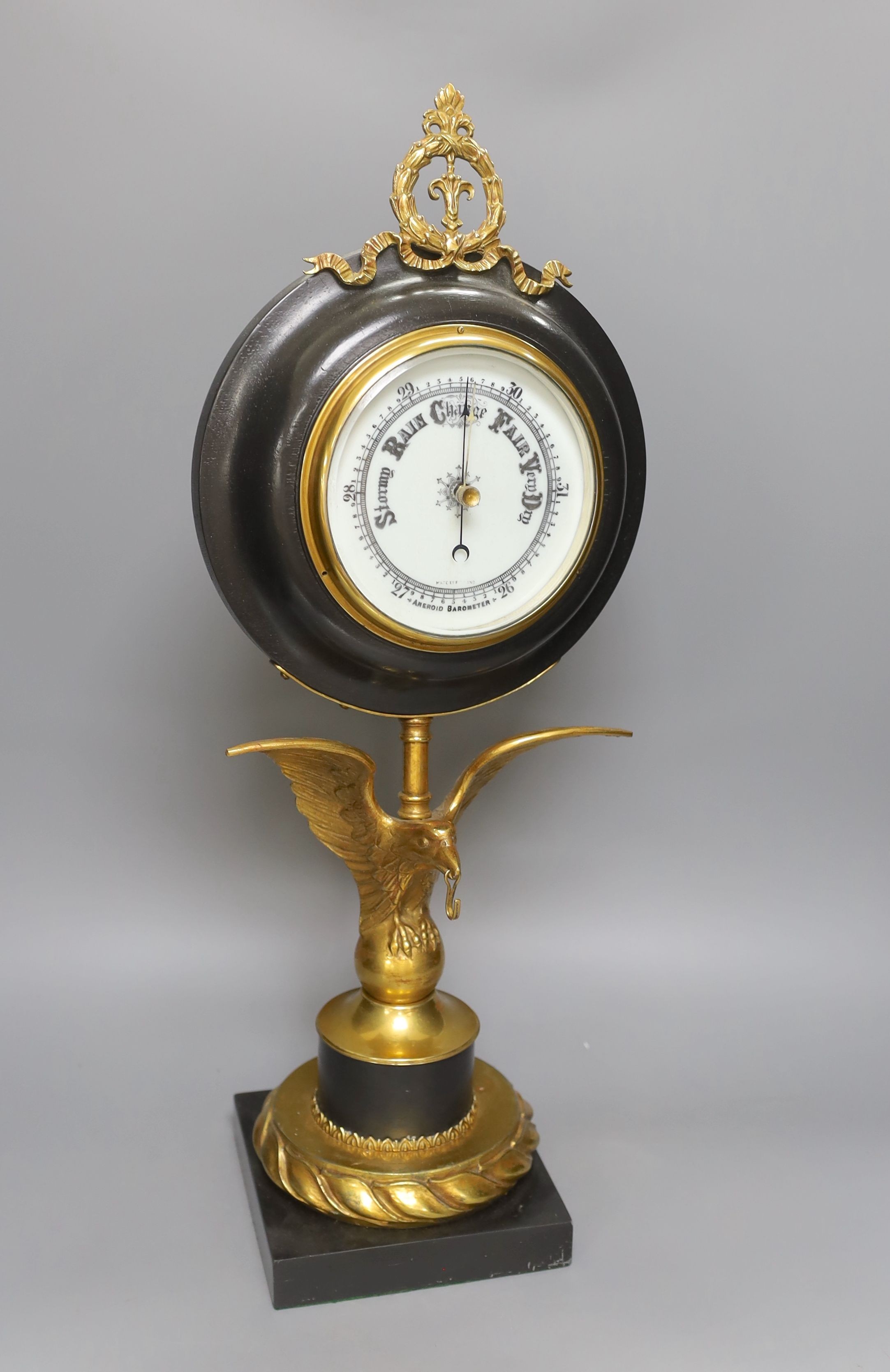 A large desk barometer on a gilt metal eagle mount - 58.5cm tall