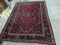 A Caucasian design burgundy ground carpet, 280 x 210cm