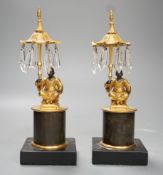A pair of Louis XVI style bronze chinoiserie lustres depicted plinth seated gentleman bearing