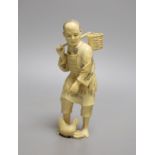 A Japanese ivory okimono of a fisherman and a chicken, Meiji period, signed, 15cm tall