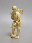 A Japanese ivory okimono of a fisherman and a chicken, Meiji period, signed, 15cm tall