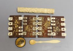 Four Japanese lacquer whist markers, a Chinese ivory needle case, a pincushion and a bone spoon,