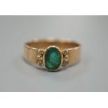 A yellow metal, oval cut emerald and six stone diamond chip set ring, size O, gross weight 3 grams.