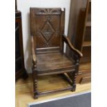 A late 17th century and later Halifax oak panel back armchair, width 52cm, depth 44cm, height 98cm