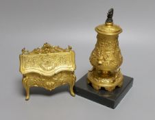 A novelty gilt metal, serpentine shaped miniature chest inkwell and a similar urn shaped inkwell,