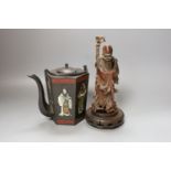 A Chinese carved hardwood figure of Shao Lao on hardwood stand and a similar painted metal teapot,