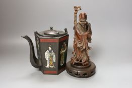 A Chinese carved hardwood figure of Shao Lao on hardwood stand and a similar painted metal teapot,