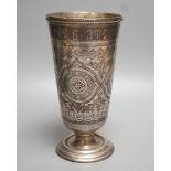 A continental white metal and niello vase, with inscription and decorated with foliate scrolls, 22.