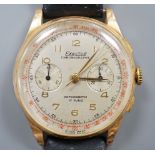 A gentleman's 1950's? 18k yellow metal Exactus manual wind chronographe wrist watch, on a black