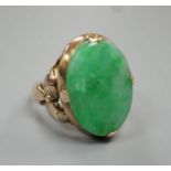 A yellow metal and oval cabochon jade set ring, size K/L, gross weight 3.5 grams.