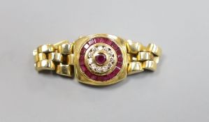 A modern 750, ruby and diamond circular cluster set ring, with articulated shank and clasp, size