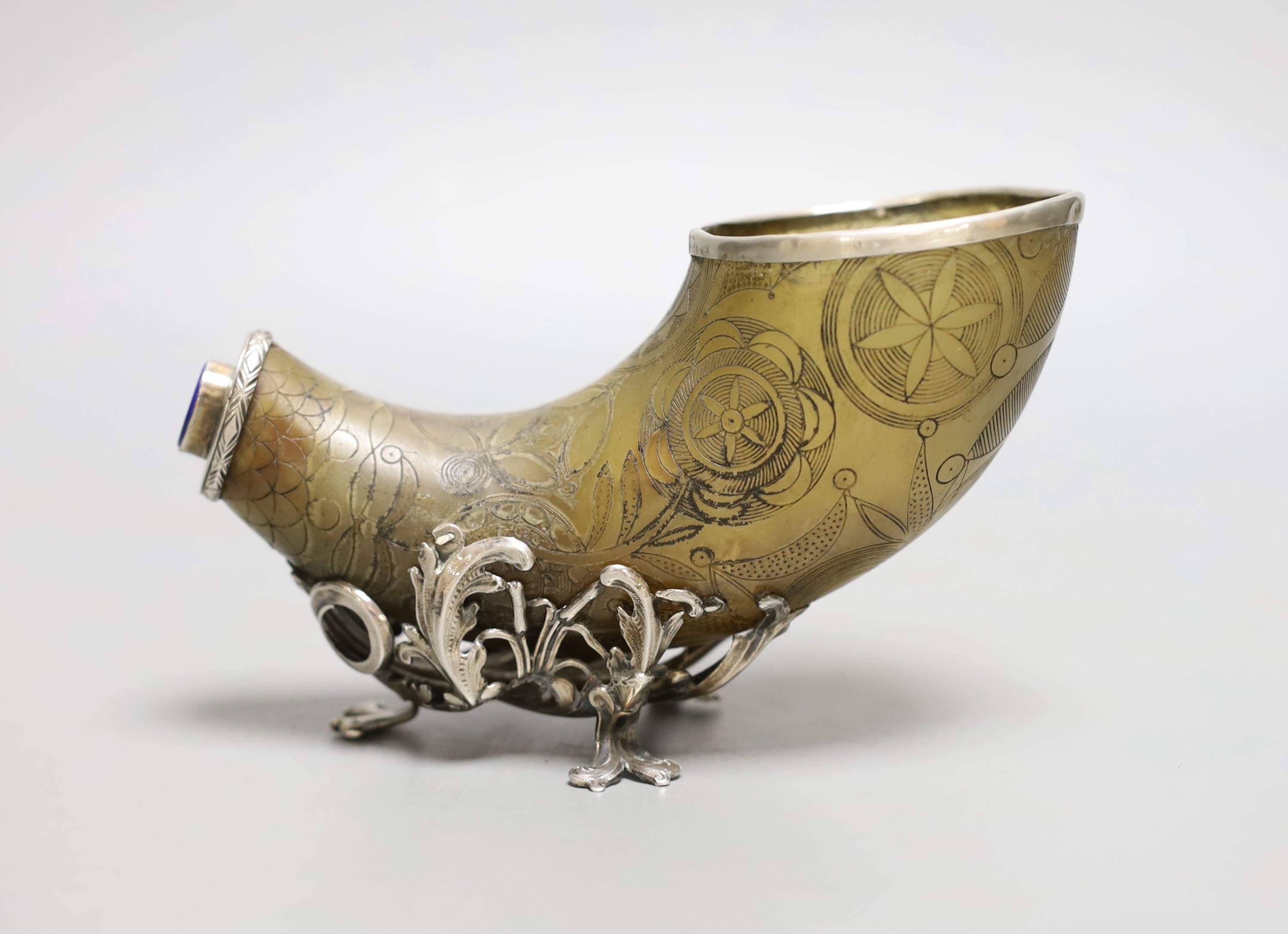 An 18th century, silver mounted decorated horn, with lapis mount,25 cms wide.