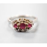 A modern 18ct white gold ruby and diamond set cluster ring, size S, gross weight 5.3 grams.