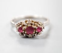 A modern 18ct white gold ruby and diamond set cluster ring, size S, gross weight 5.3 grams.