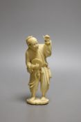 A Japanese ivory okimono of a man holding a turtle or terrapin, Meiji period - 13.5cm tall