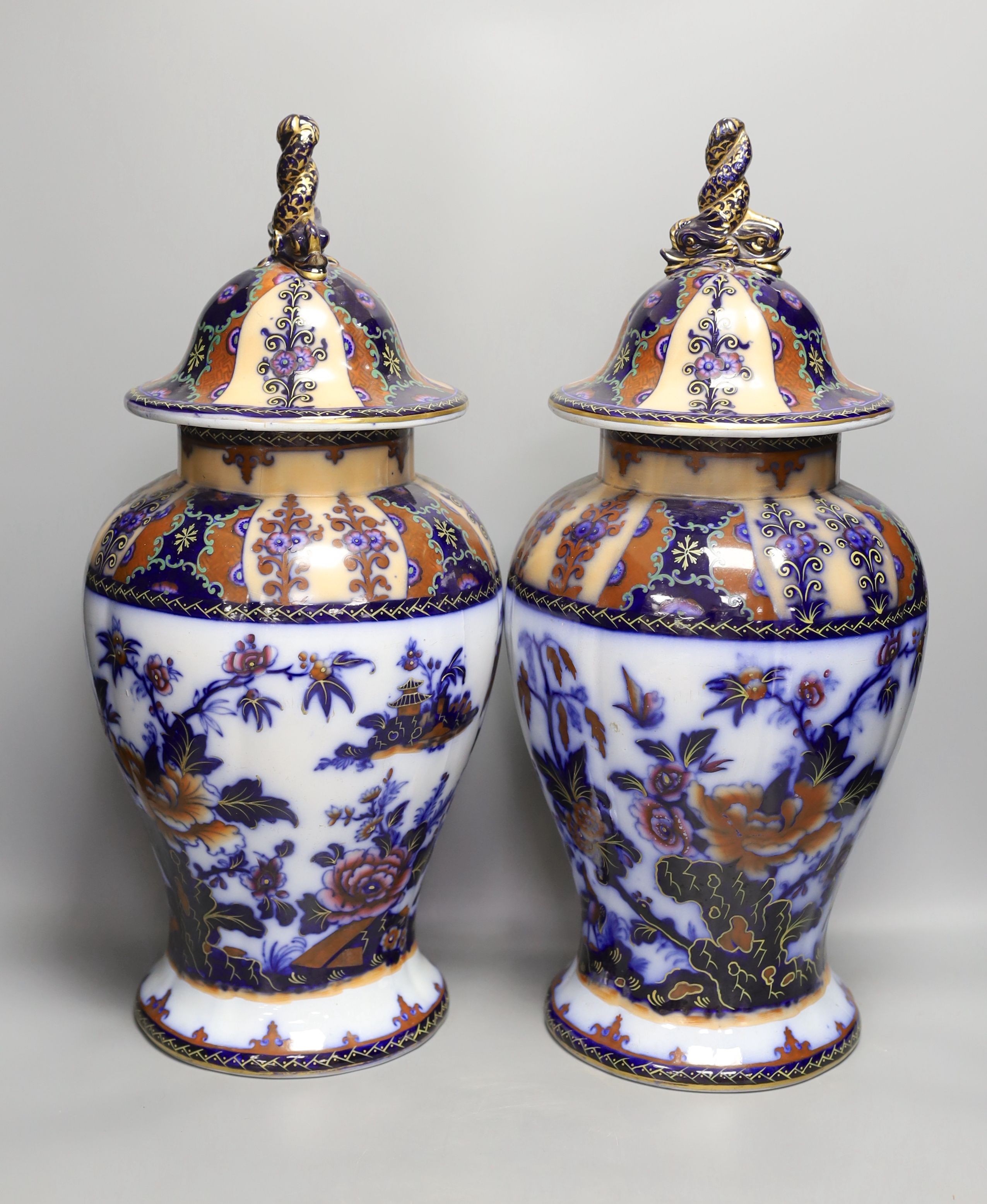 A pair of mid 19th century ironstone vases and covers - 51cm tall