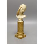 An 18th/19th century grand tour ivory bust of a lady on a Siena marble pedestal, 24cm