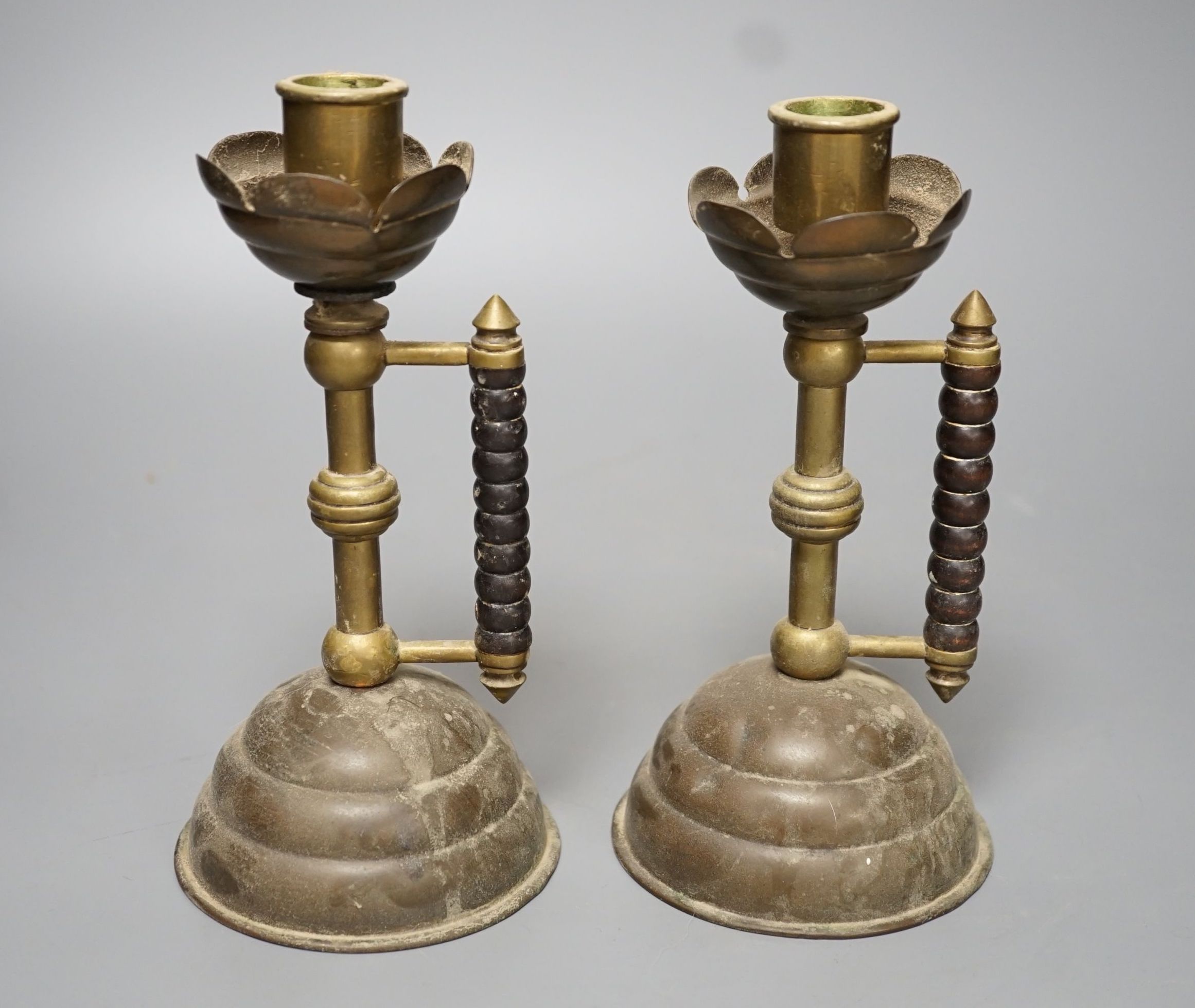 A pair of Gothic brass stem cup and handled candlesticks - 19.5cm high