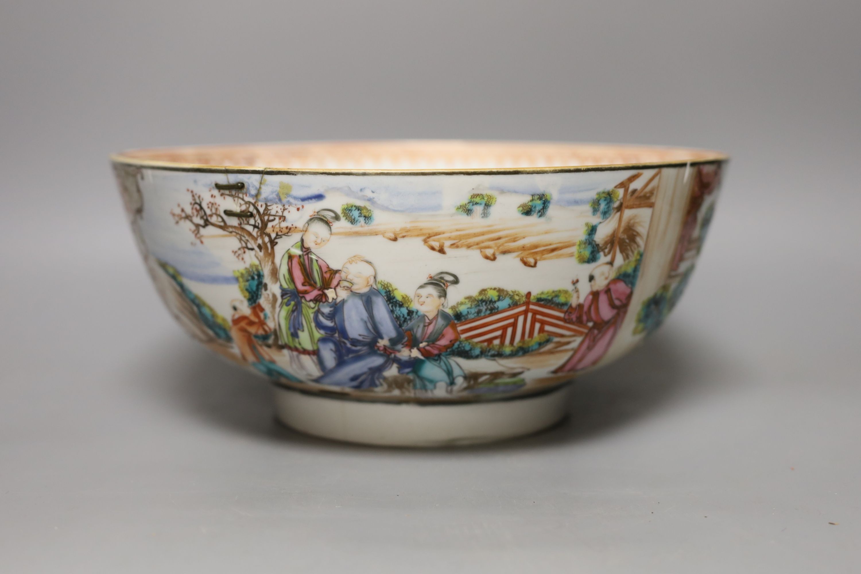 An 18th century Chinese export famille rose punch bowl (with historic damage and riveted repair)