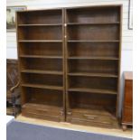 A pair of Hungarian mahogany and pine open fronted bookcases, with adjustable shelving, each width