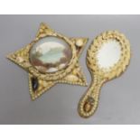 A shell mounted star with central scenic seascape and a shell hand mirror, star 24 cms wide.