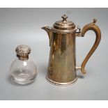 A George V silver hot water pot, London, 1934, gross 15oz and a silver topped glass scent bottle.