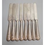 A set of seven Edwardian silver fiddle and shell pattern dessert knives, Goldsmiths & Silversmiths