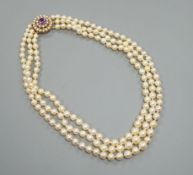 A triple strand cultured pearl choker necklace, with a yellow metal, amethyst and cultured pearl set