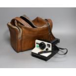 A Polaroid 'card' camera in brown leather case