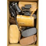 A box of binoculars and cameras - some cased