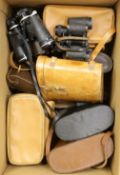 A box of binoculars and cameras - some cased