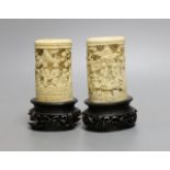 A pair of 19th century Chinese carved ivory brushpots on wooden stands - 12cm tall (including