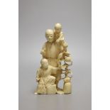 A Japanese carved ivory okimono of a farmer and two boys, Meiji period - 12.5cm tall