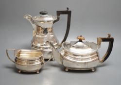 A George V matched silver part tea set, comprising a hot water pot, teapot and sugar bowl, different