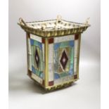 A stained glass and brass hanging hall lantern, 36cm to top of ‘eyes’