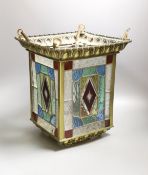 A stained glass and brass hanging hall lantern, 36cm to top of ‘eyes’