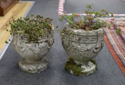 A pair of small reconstituted stone circular garden planters, diameter 23cm, height 28cm